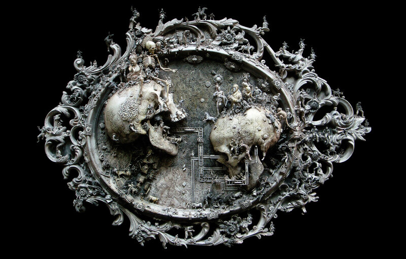 Ornate skull sculpture with figures