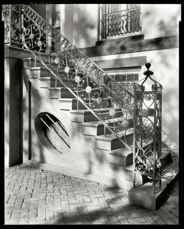 Ornate staircase with wrought iron railings