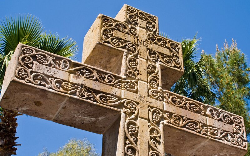 ornate stone cross with grape motifs