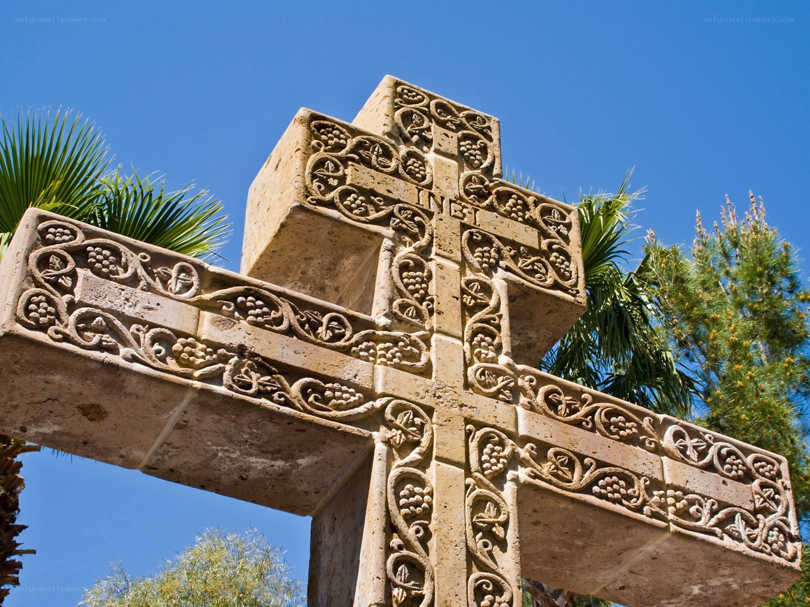 ornate stone cross with vines