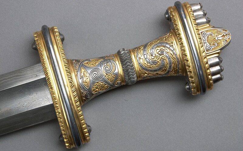 ornate sword with gold and silver inlay