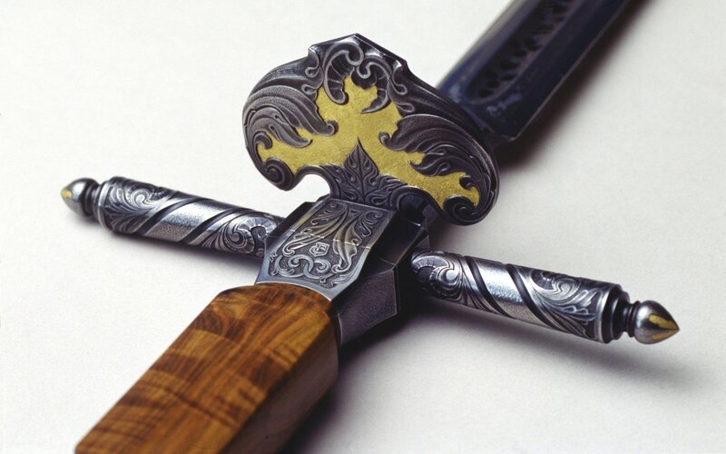 ornate sword with gold cross