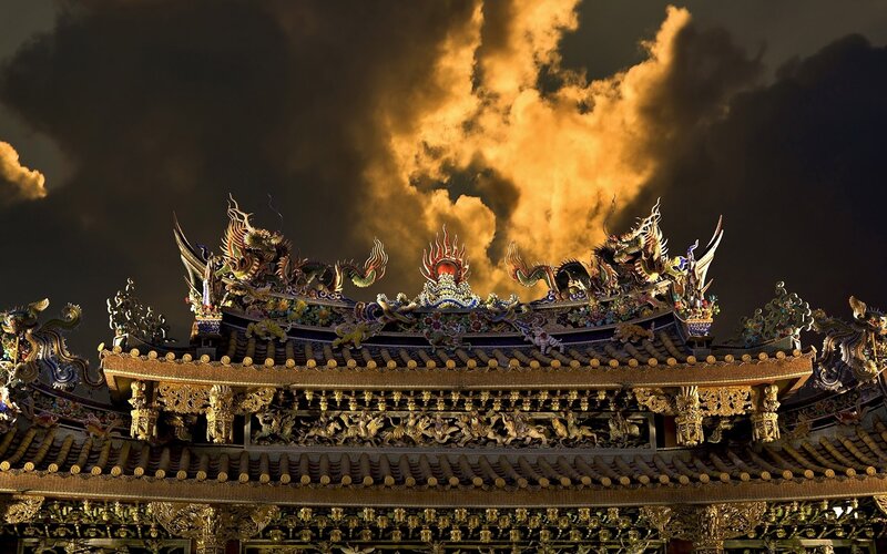 ornate temple roof at sunset