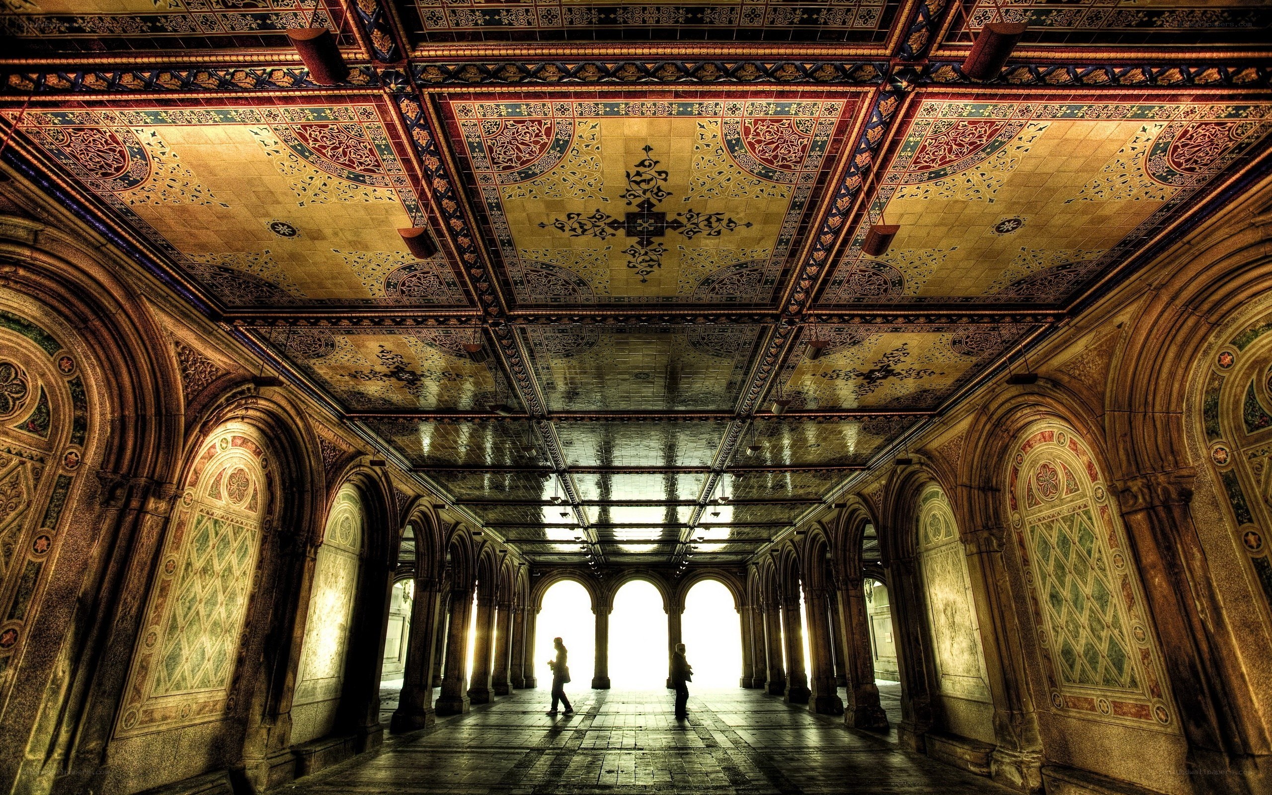 ornate tiled hallway with arches