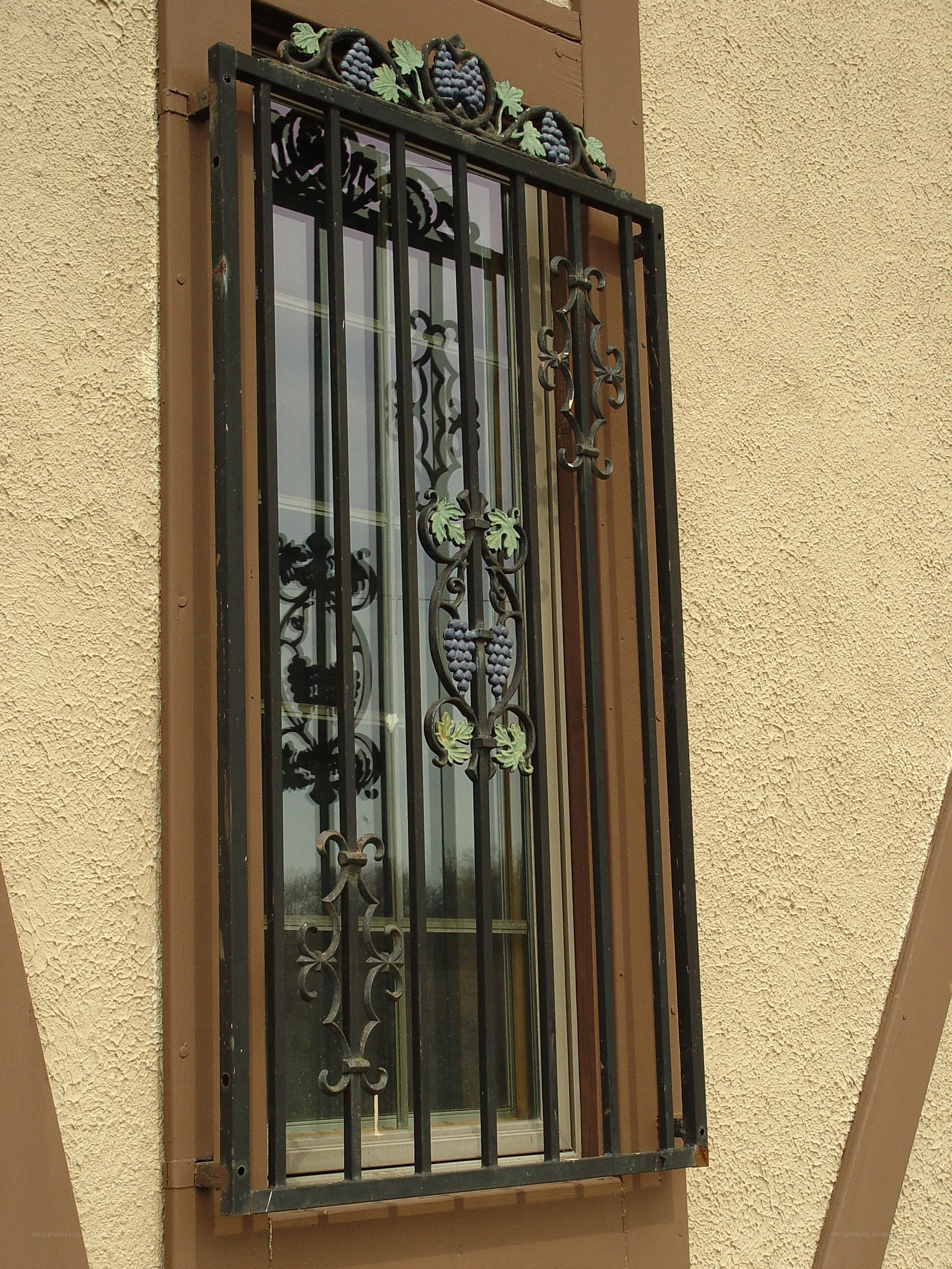 ornate window grille with grape motif