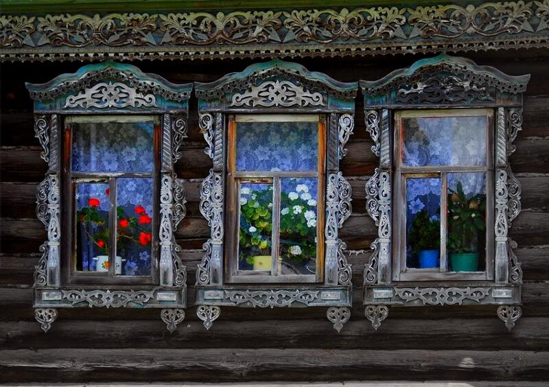 Ornate windows on a wooden house