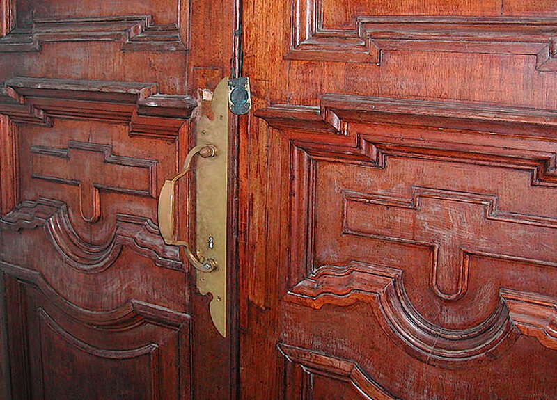 ornate wooden door with brass hardware
