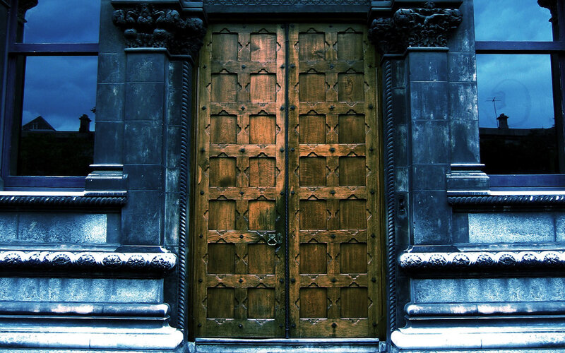 ornate wooden doors at dusk