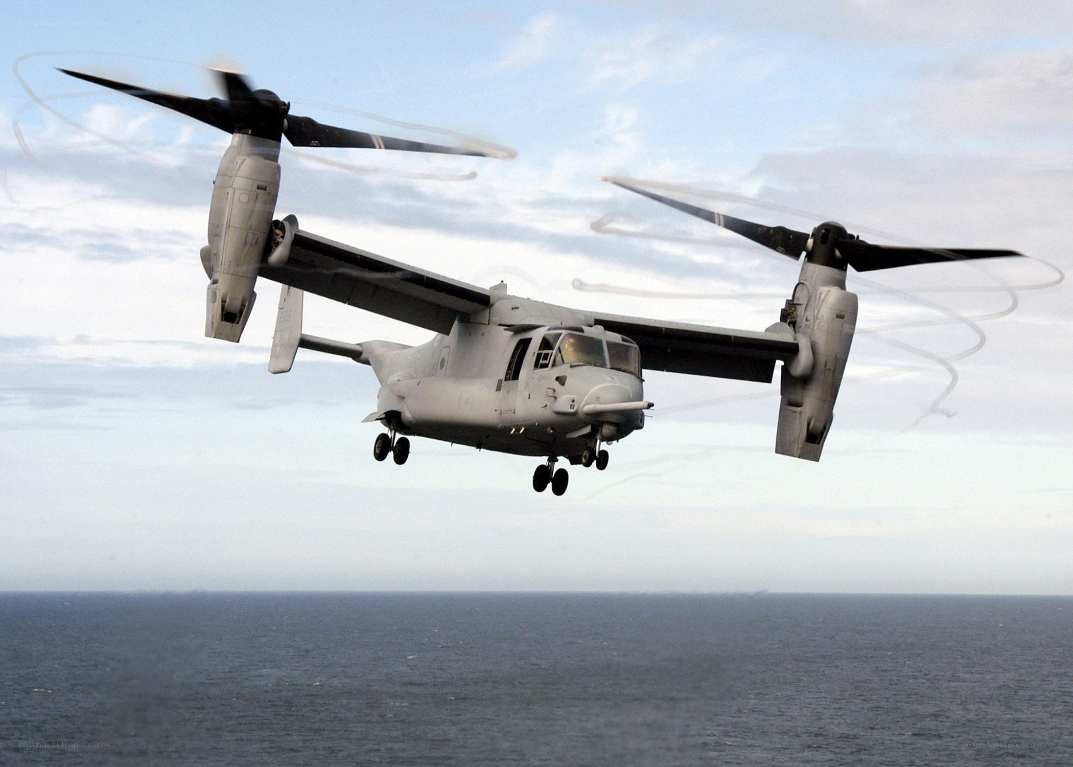 Osprey aircraft in flight over ocean