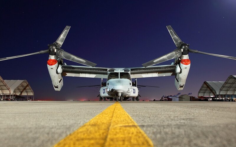 Osprey aircraft on tarmac at night