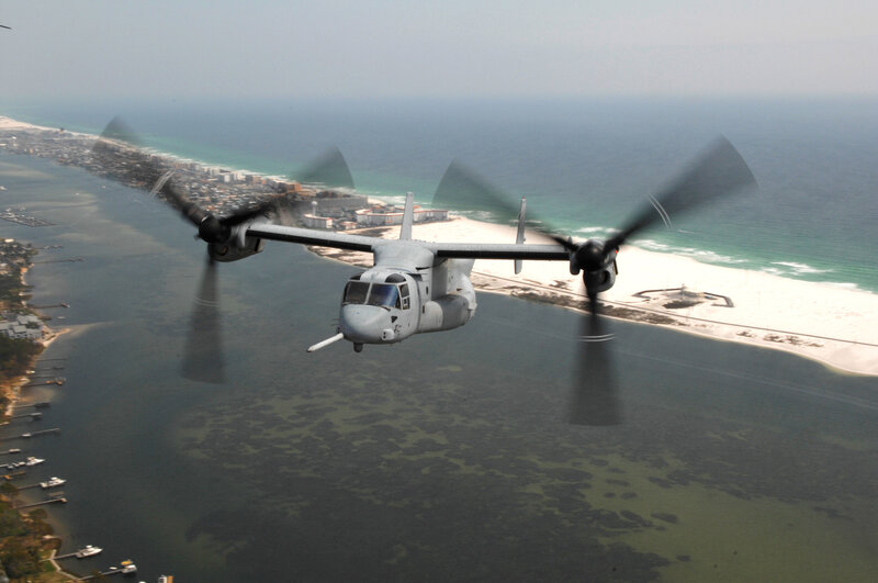 Osprey aircraft over coastal area