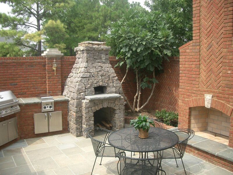 Outdoor kitchen with stone fireplace
