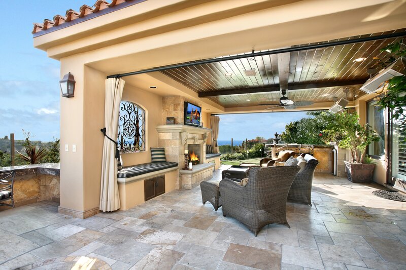 Outdoor patio with fireplace and ocean view