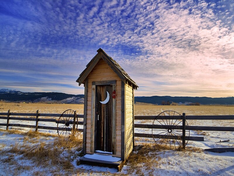 Outhouse in Snowy Field