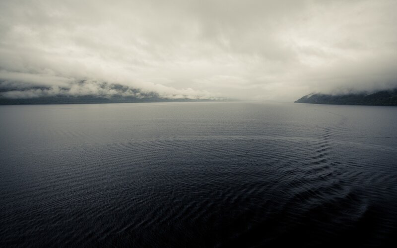 overcast lake with mountains