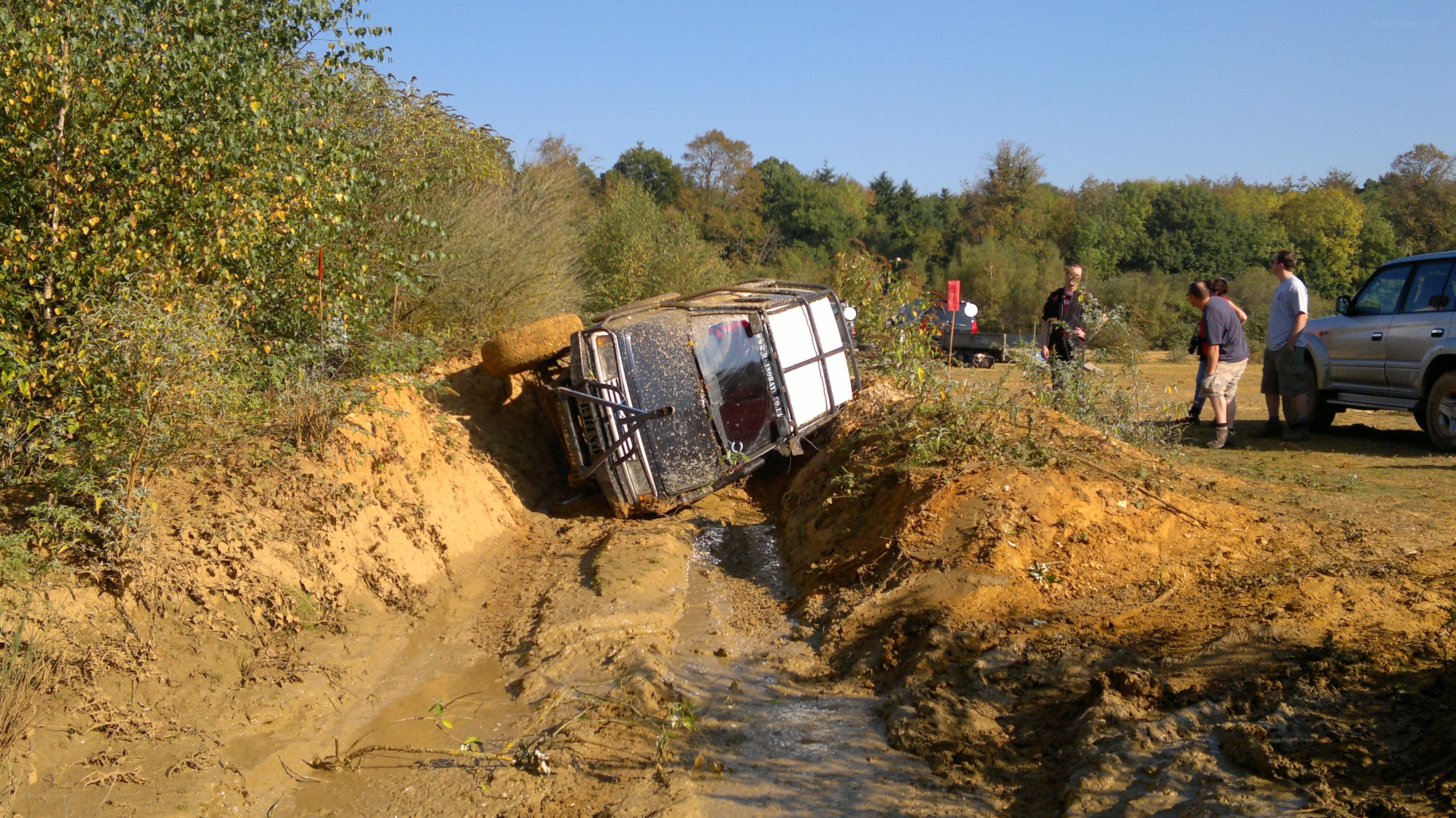 Overturned off-road vehicle in mud