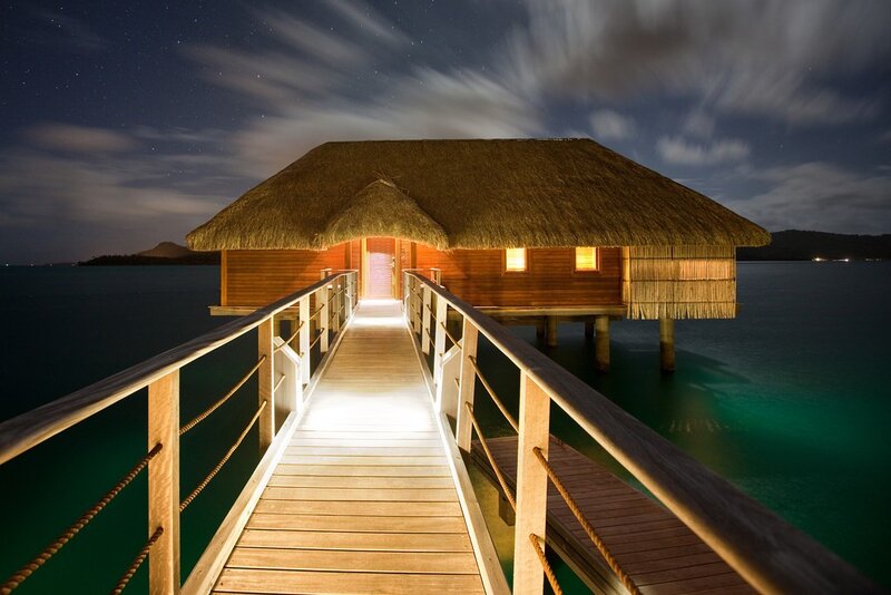 Overwater bungalow at night