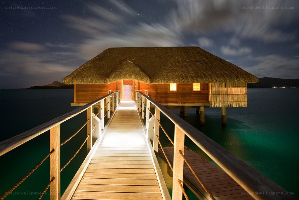 Overwater bungalow at night