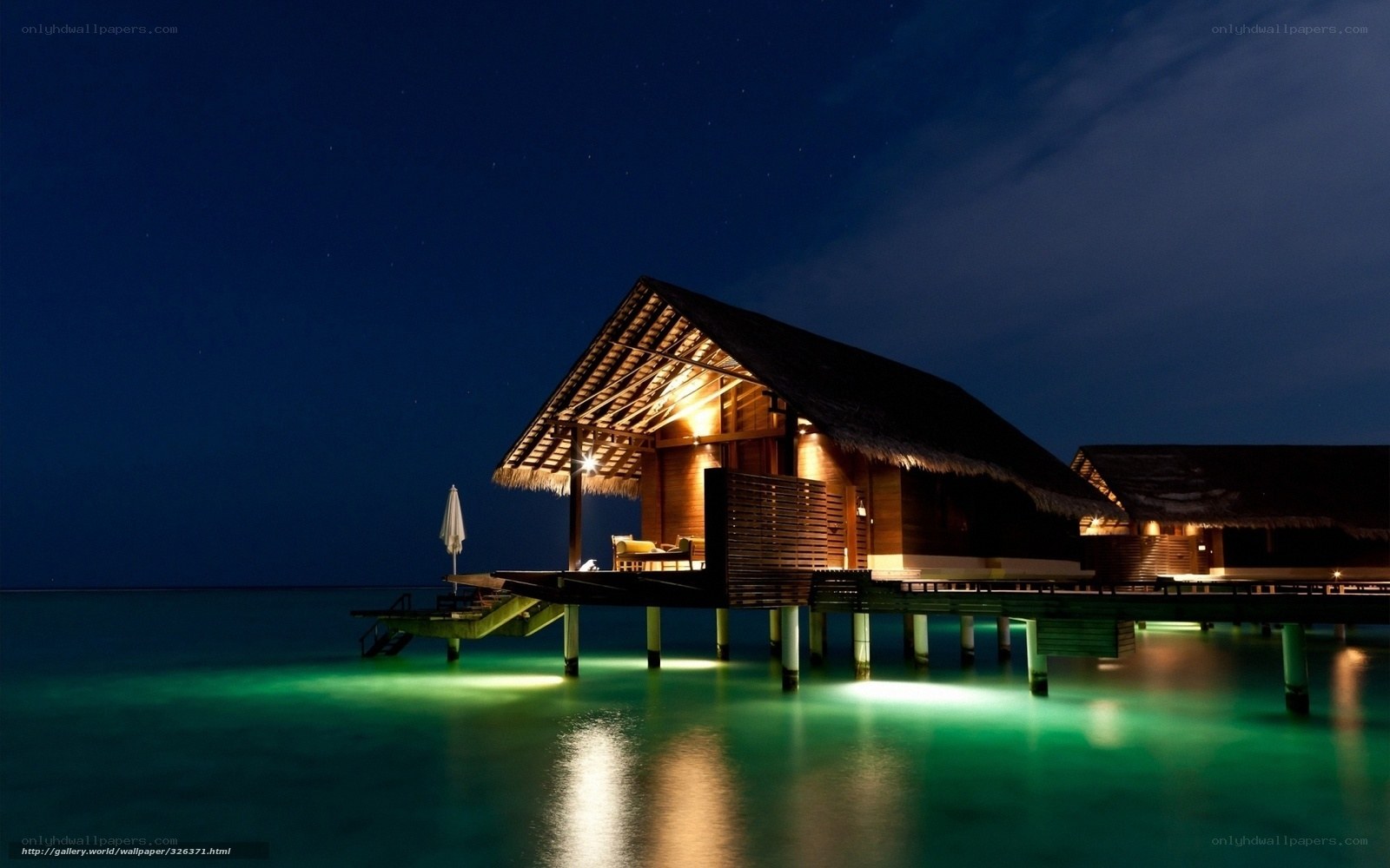 Overwater bungalow at night