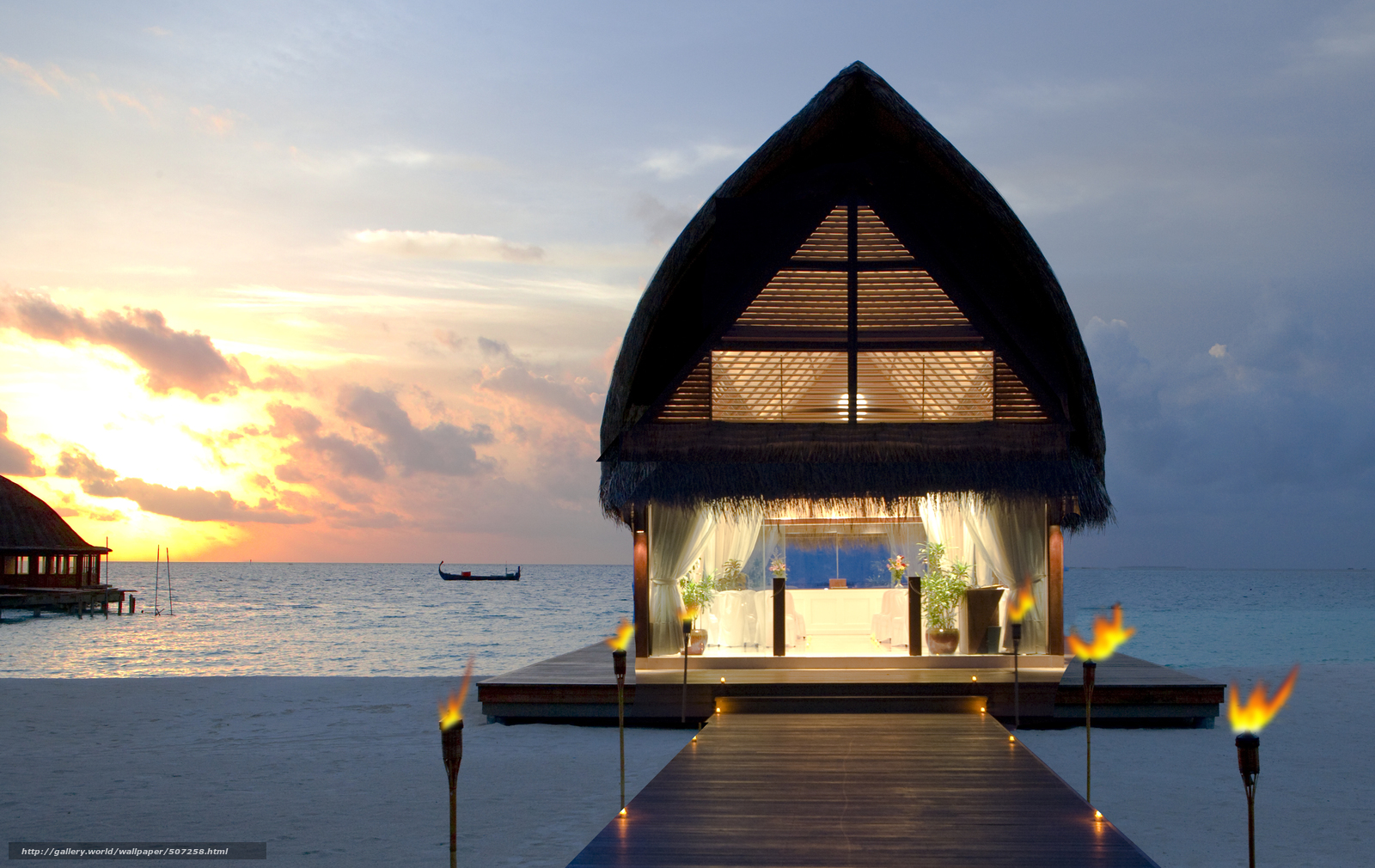 Overwater bungalow at sunset