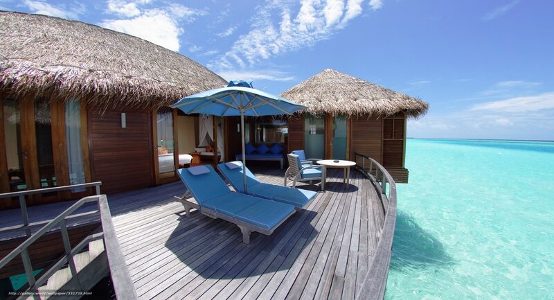 Overwater bungalow with lounge chairs