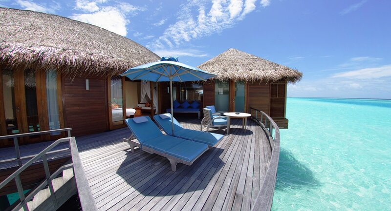Overwater bungalow with lounge chairs