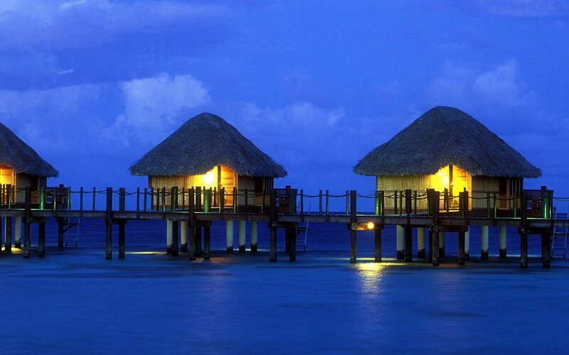 Overwater bungalows at dusk