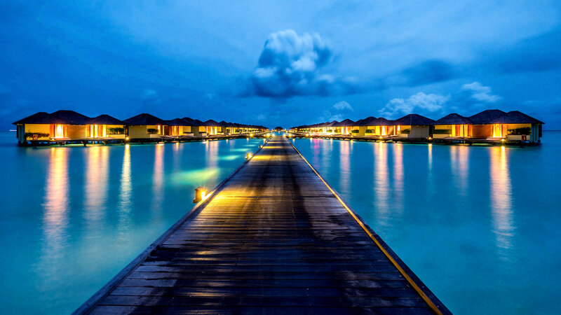 Overwater Bungalows at Dusk — Blue, Serene, Night, Photograph, Pier, Clouds