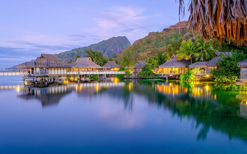 Overwater Bungalows at Dusk — Blue, Serene, Sunset, Photograph, Mountains
