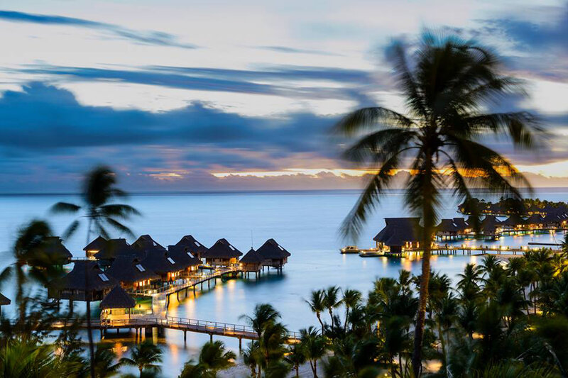 Overwater Bungalows at Dusk — Blue, Serene, Sunset, Photograph, Palm Trees