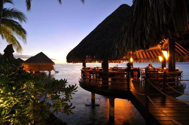 Overwater Bungalows at Dusk — Blue, Serene, Sunset, Photograph, Thatched Roofs