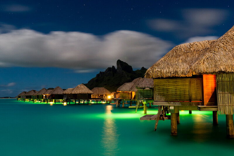 Overwater Bungalows at Night — Blue, Serene, Photograph, Thatched Roofs