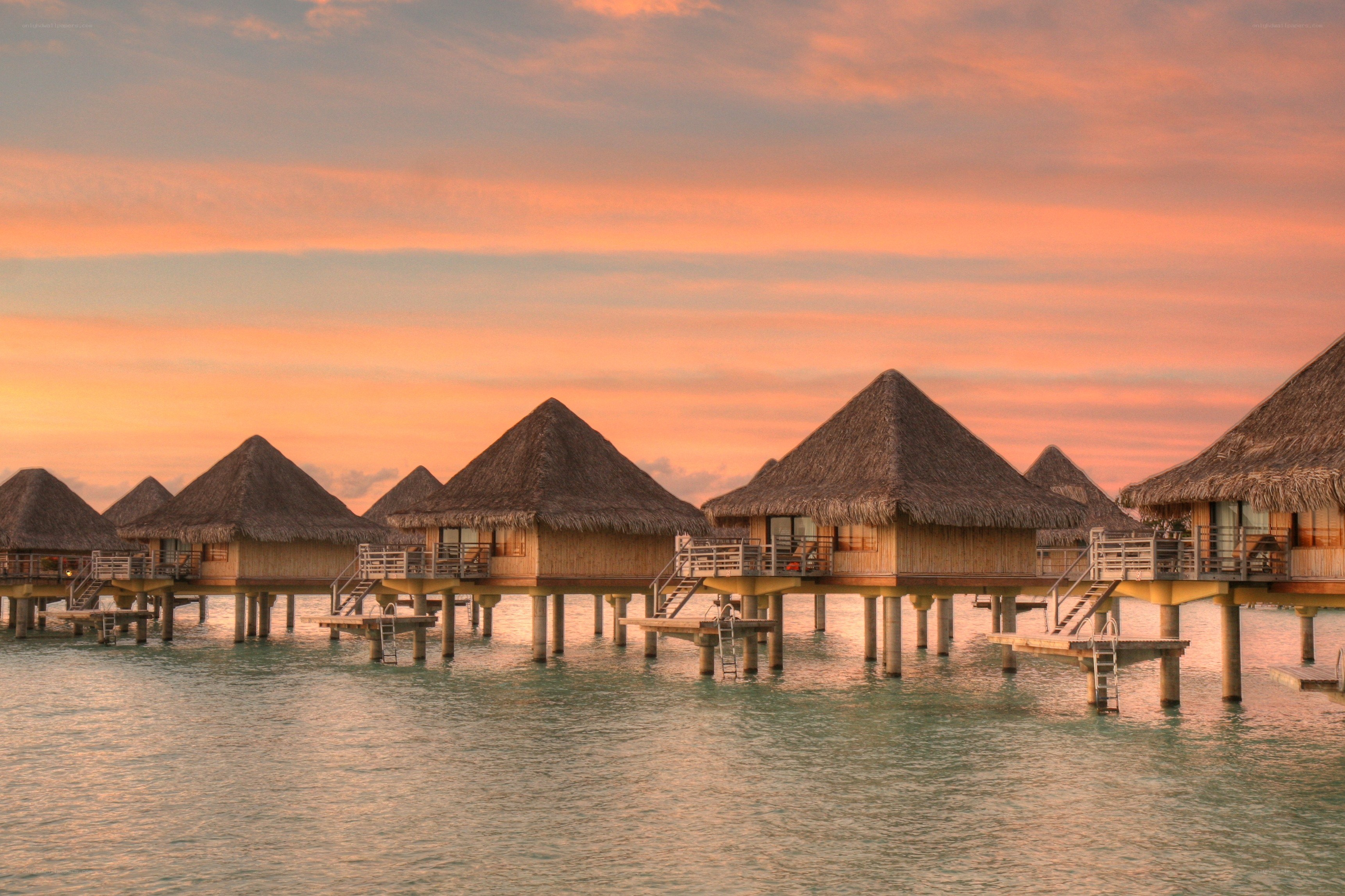 Overwater bungalows at sunset