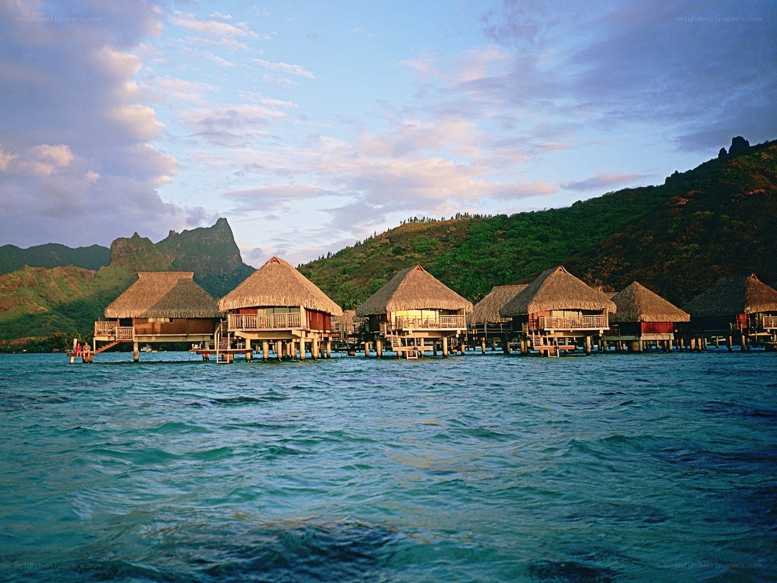 Overwater bungalows at sunset