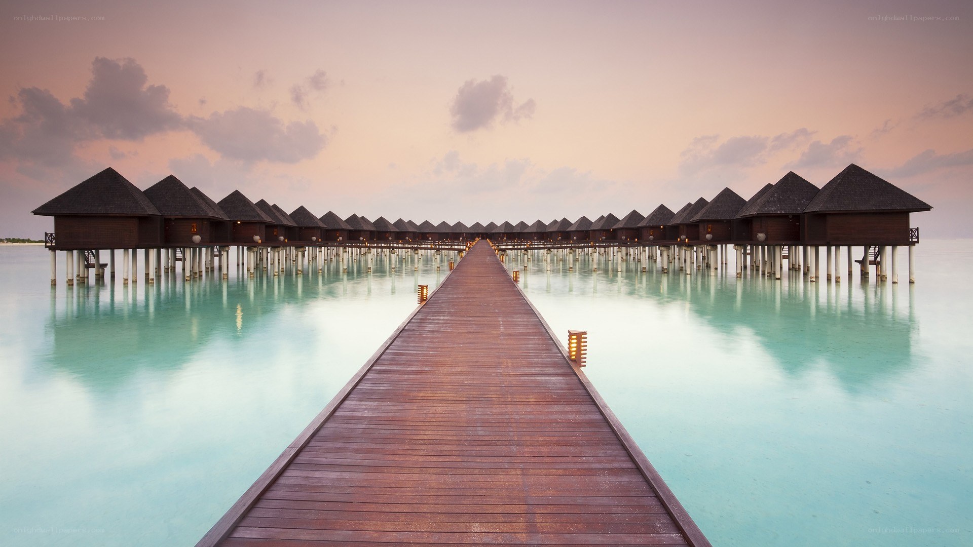 Overwater bungalows at sunset