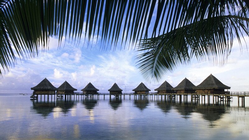 Overwater bungalows at sunset