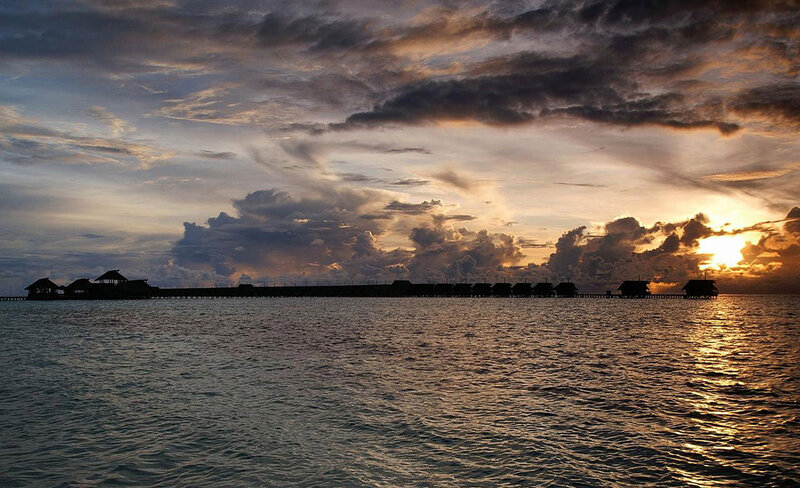 Overwater Bungalows at Sunset — Orange, Dramatic, Photograph