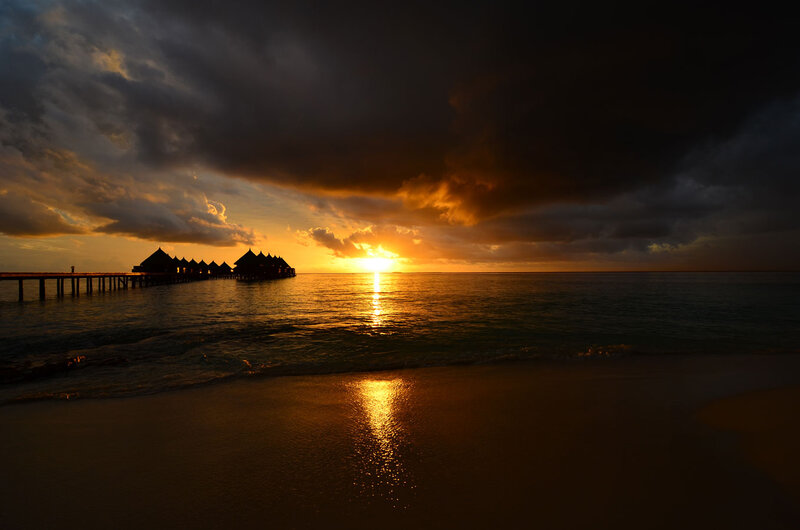 Overwater Bungalows at Sunset — Orange, Dramatic