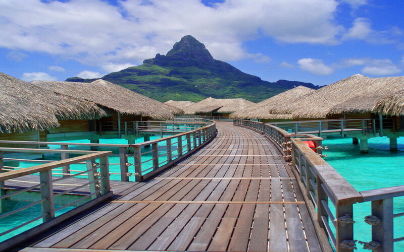 Overwater Bungalows — Blue, Serene, Afternoon, Photograph, Mountain, Thatched Roofs
