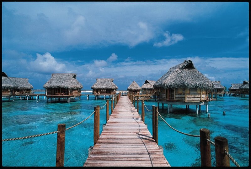Overwater Bungalows — Blue, Serene, Afternoon, Photograph, Pier, Thatched Roofs