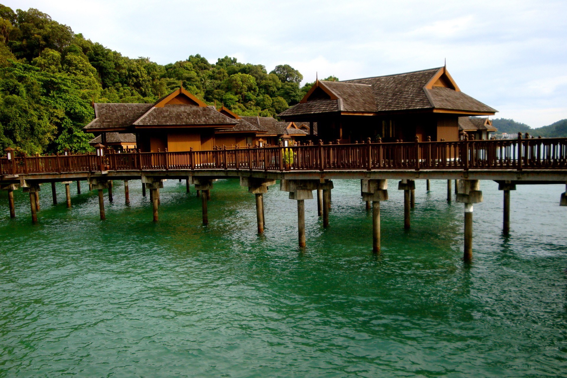Overwater bungalows in tropical setting