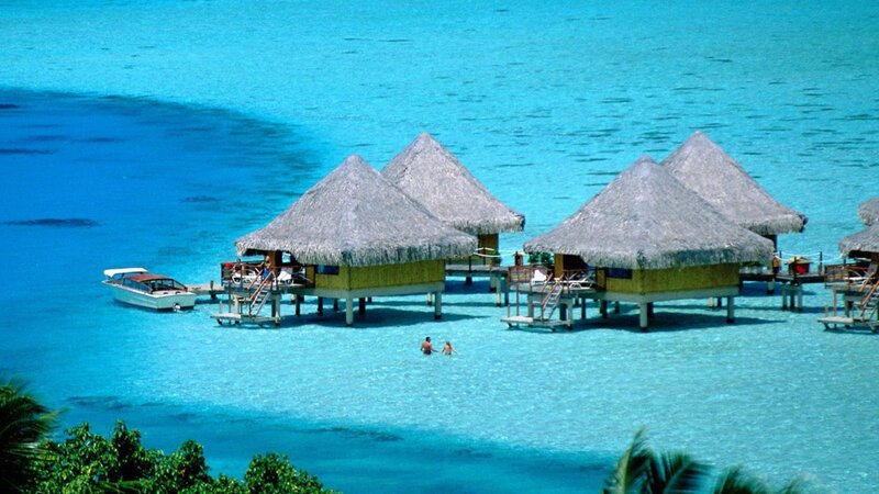 Overwater bungalows in turquoise water