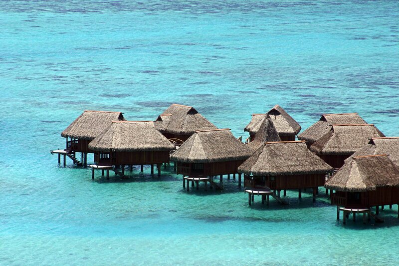 Overwater bungalows in turquoise water