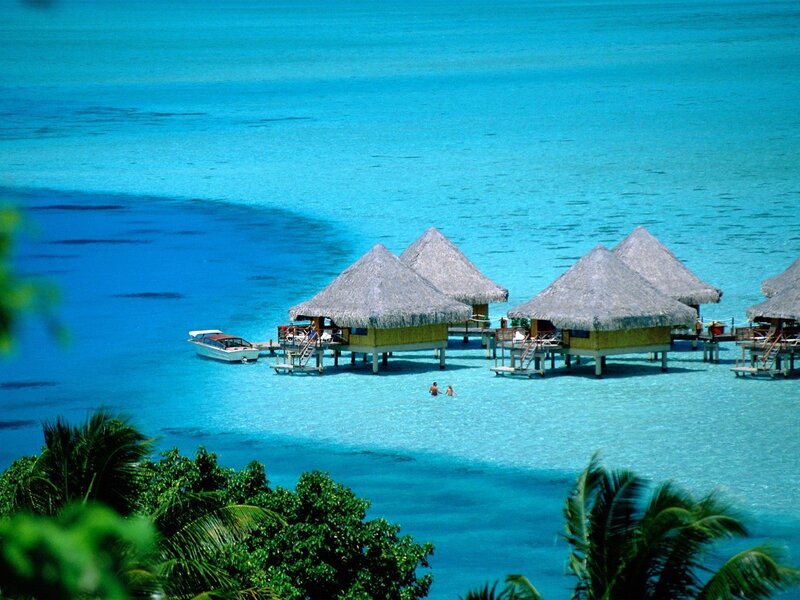 Overwater bungalows in turquoise water