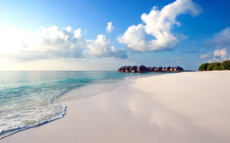 Overwater Bungalows on Beach — Blue, Serene, Afternoon, Photograph, Ocean, Clouds, Trees