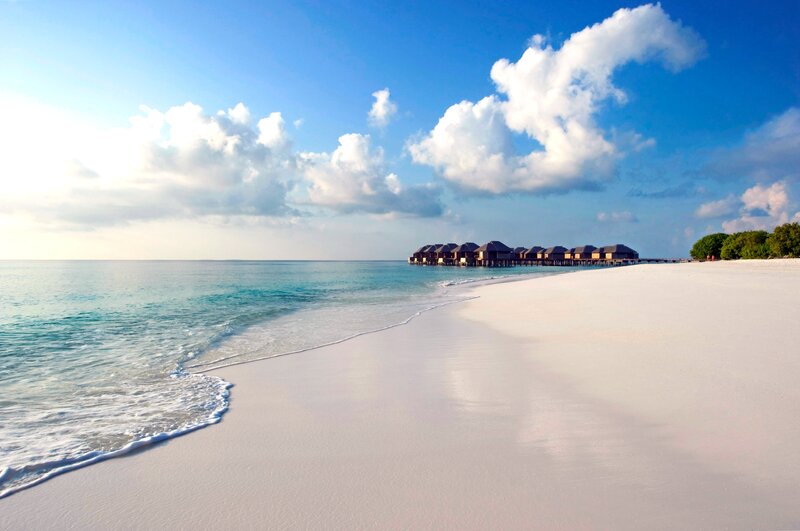 Overwater Bungalows on Beach — Blue, Serene, Afternoon, Photograph, Ocean, Clouds, Trees, White