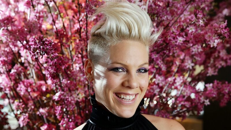 P!nk smiling in front of flowers