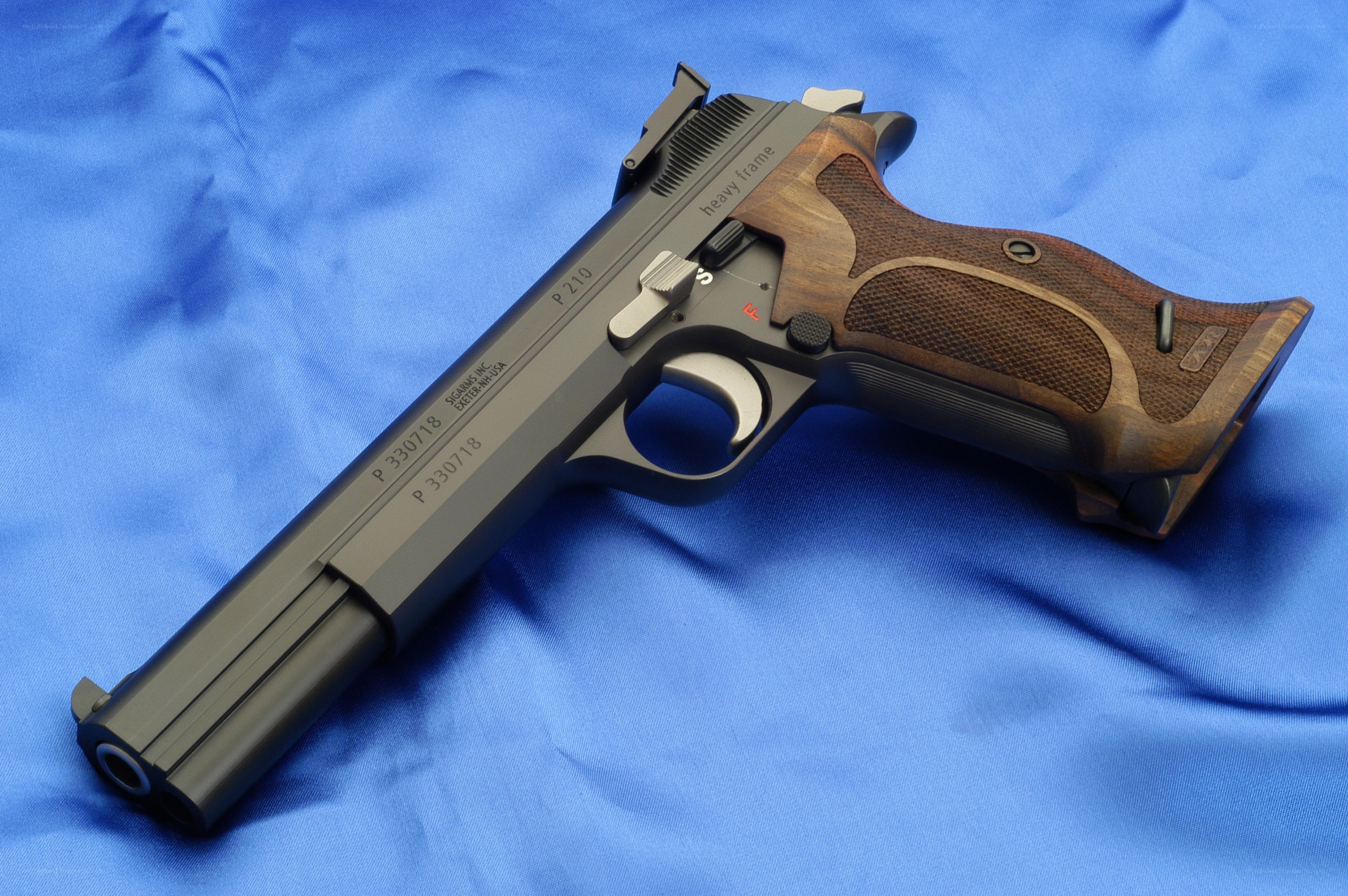 P210 pistol on blue cloth