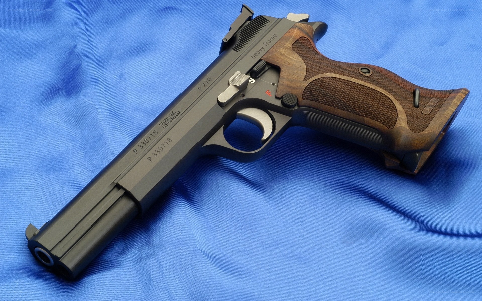 P210 pistol on blue cloth