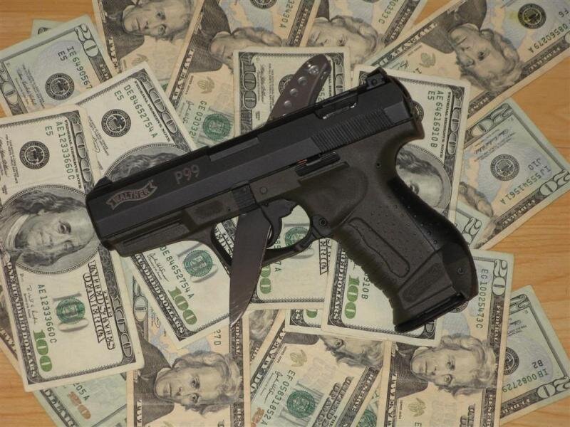 P99 pistol on money